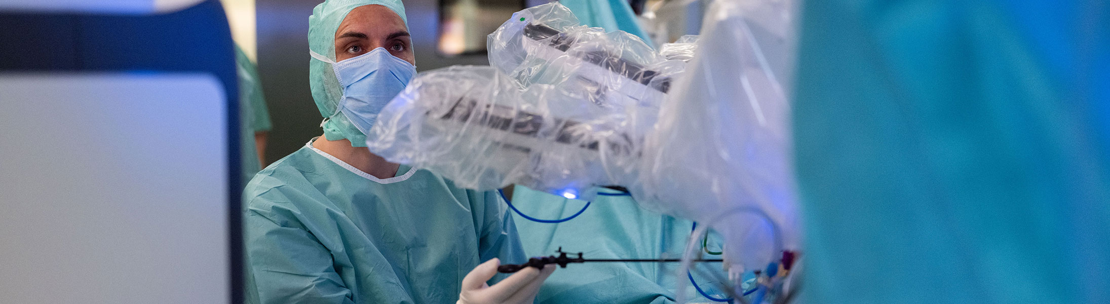 Chirurg bei einer robotergestützten minimal-invasiven Operation mit moderner OP-Technologie.